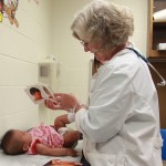 Reach Out and Read Kansas City Medical Director, Sallie Page-Goertz, during a well-child visit with four month old Katie.