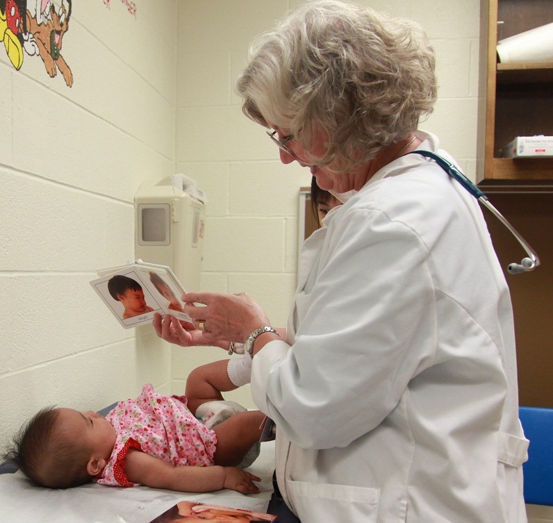 Reach Out and Read Kansas City Medical Director, Sallie Page-Goertz, during a well-child visit with four month old Katie.